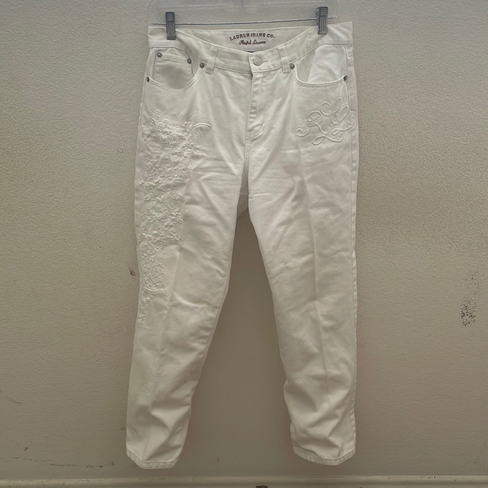 White straight leg pants with embroidered details.